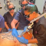 Laser tattoo removal students gaining hands-on experience.